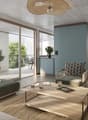 Modern living room with large windows, a sofa, coffee table, dining area, and decorative plants.