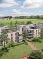Building. Aerial view of a modern residential complex with multiple apartment buildings, green spaces, and pathways.