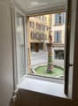 View from window showing a fountain in a street outside
