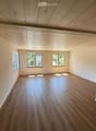 empty room, hardwood floors, white walls, three windows, wooden ceiling