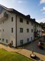 3 story house, white exterior, green shutters, balcony, garden, parking