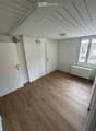 empty room, white walls, wooden floors, windows, wooden doors, light fixture