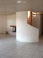 empty room, white tiles, fireplace, spiral staircase, window