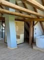 wooden beams, wooden floor, white bathtub, shower, sauna, wooden wall