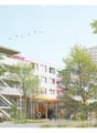 A modern multi-story residential building with colorful facades, balconies, and a central staircase leading to a communal outdoor area with trees and seating.