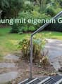 Garden with lawn, pathway, plants, bushes, stone step, railings