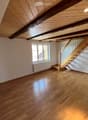 empty room, wooden floor, wooden ceiling, white walls, window, radiator, staircase
