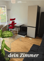 Modern living room with a black sofa, red chair, glass coffee table, and a large leafy plant near the window offering a view.