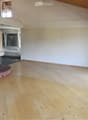 wooden floor, white walls, fireplace, glass doors, balcony
