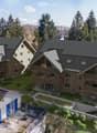 Aerial view, modern house design, raised ground floor, terrace, large windows, multiple balconies, green landscaping, solar panels, distant mountain view