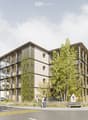 Modern multi-story building with a contemporary design, featuring large windows, balconies, and greenery integrated into the facade. The building is surrounded by trees and a paved area with a bench.