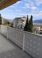 tiled floor, metal railing, balcony, view of the city and mountains
