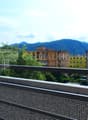 Terrace with metal railing, panoramic view, mountains in the background
