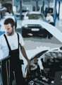 mechanic working in a car repair shop, diagnostic tools, car open for repair