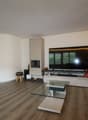 modern decor, living room, fireplace, red sofa, glass coffee table, TV, cabinet