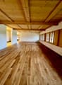 empty room, wooden floor, wooden ceiling, white walls, windows