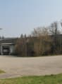 Warehouse building with three loading doors, signage on the wall