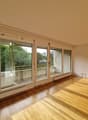 empty room, wooden floor, sliding glass doors, balcony, white walls, white ceiling
