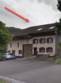 2 story house, brown roof, white windows, brown door, car parked in front