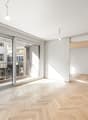 empty room, wooden parquet floor, large glass doors, balcony, white walls
