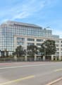 large building, glass windows, modern architecture, trees, street lights, large road