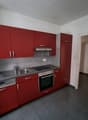 Red cabinets, stainless steel appliances, granite countertop, modern kitchen design