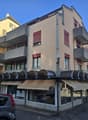 3 story building, balconies, awnings, storefront