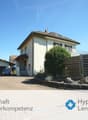 2 story house, white exterior, brown roof, attached garage, driveway, trees, shrubs