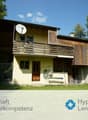 2 story house, wooden balcony, satellite dish, brick wall, garden