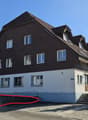 2 story house, brown roof, white walls, multiple windows, stairs, plants