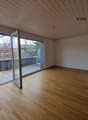 Empty studio with wooden floor, glass sliding doors, balcony, and wooden ceiling.