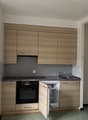 modern wooden cabinets, granite countertop, stainless steel sink, oven, refrigerator