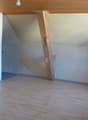 empty room, wooden beam, electrical outlet, wooden floor, windows, ceiling lamp