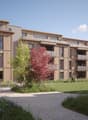 Multiple balcony, modern design, multiple floors, central garden area, surrounded by grass and trees