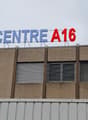 A multi-story commercial building with the text 'CENTRE A16' displayed prominently on the facade.