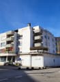 modern multi-story apartment building, balconies on multiple floors, modern architecture, clear sky