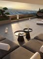 Outdoor terrace with lounge chairs, tables, and a view of the mountains