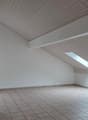 empty room with ceiling and floor made of tiles, white walls, one window and a chimney