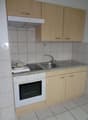 kitchen with oven, sink, cabinets, tiled floor