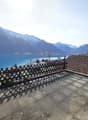 Roof terrace with a view of a lake and mountains