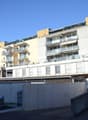 multiple story apartment building, balconies, yellow and white paint