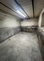 empty garage with concrete floor and walls, ceiling with fluorescent light