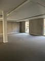 empty room, concrete walls, glass windows, gray carpet