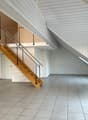 empty room, wooden stairs, white walls, tiled floor, metal railings, balcony