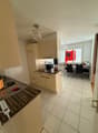 kitchen with dining area, white tiles, wooden countertops, white cabinets, chandelier, dining table, chairs, flags