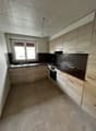 modern kitchen with wooden cabinets, tiled floor, sink, oven, dishwasher, window with blinds