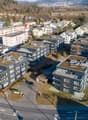 Residential apartment buildings with green roofs, parking, modern architecture, central location, green areas and trees