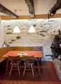 wooden table, chairs, stone walls, fireplace