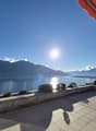 tiled floor, view of lake and mountains, shadow, railing, orange awning