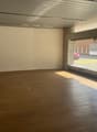 Open room, wooden floor, glass window with a view of a road